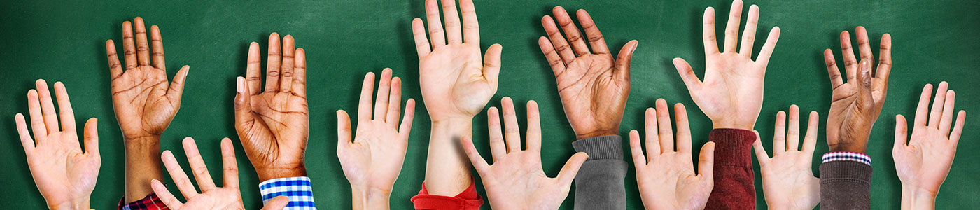 Young raised hands with Chalkboard in the Background