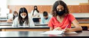 Face masked students taking an exam